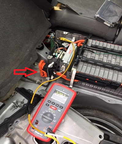 Arrow shows High Voltage Service Plug.