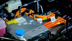Under the hood of an EV. Industry-standard orange color is applied to all high voltage cabling. Under the hood of an EV. Industry-standard orange color is applied to all high voltage cabling.