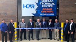 I-CAR&rsquo;s Board of Directors Chair Kyle Thompson (center) is shown ready to cut the ribbon at the main entrance to the 48,000-square-foot facility. He is flanked by members of I-CAR&rsquo;s leadership, including CEO &amp; President John Van Alstyne (fourth from right). From l. are Mike Mertes, Tom Marek, James Busam, Jeff Peevy, Thompson, Tim O&rsquo;Day, Van Alstyne, Jon Petrillo, Bud Center, and Dirk Fuchs.