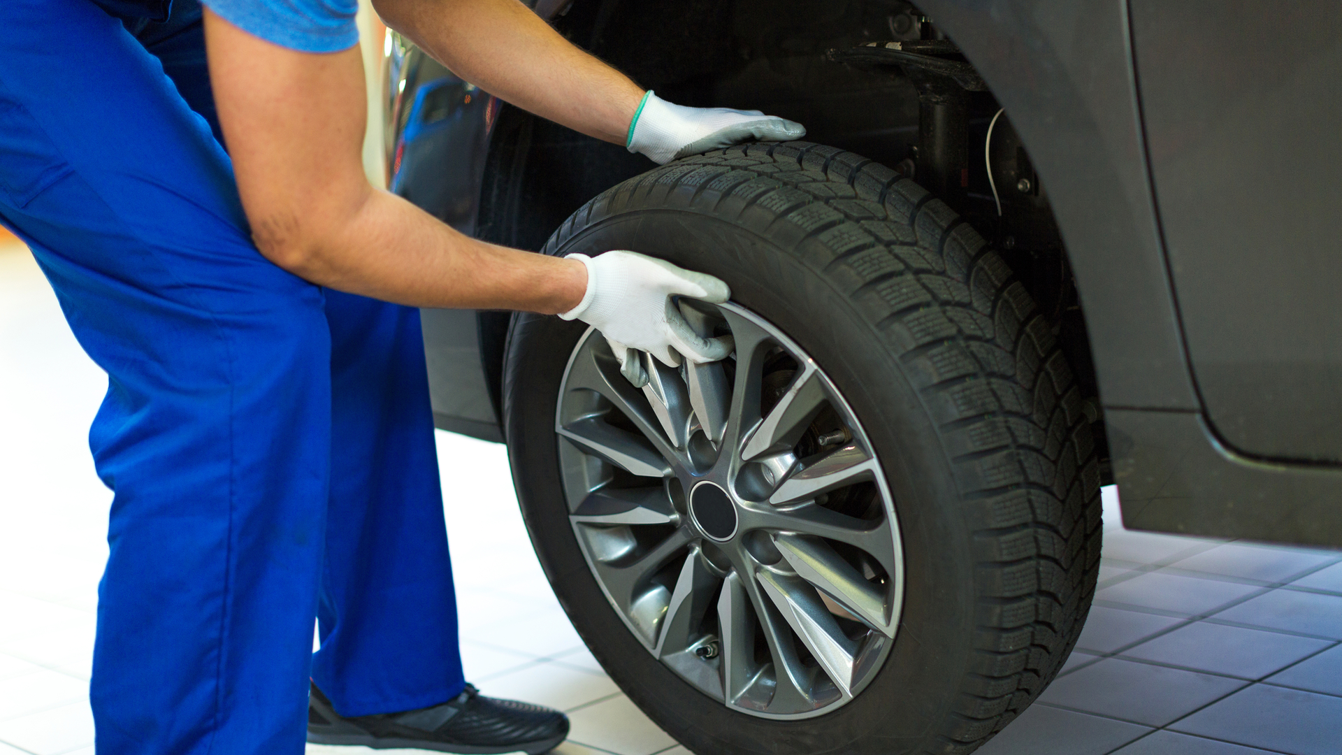 mechanic putting on a tire