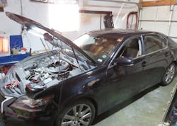 Figure 1- Upon arrival at the repair site, I found a pile of old spark plugs, a disconnected air inlet boot, and some interesting harness modifications. Figure 1- Upon arrival at the repair site, I found a pile of old spark plugs, a disconnected air inlet boot, and some interesting harness modifications.