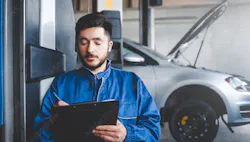 Technician writing on a clipboard