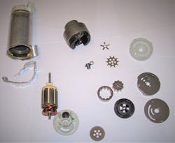 Figure 2 - After the electric pump is removed from the plastic modular assembly, the metal cylindrical electric pump can be snipped (as shown) or scored with a pipe cutter (heavier cast body motors) to be completely dissected to inspect the impeller, turbine, check valve and armature / brushes. Figure 2 - After the electric pump is removed from the plastic modular assembly, the metal cylindrical electric pump can be snipped (as shown) or scored with a pipe cutter (heavier cast body motors) to be completely dissected to inspect the impeller, turbine, check valve and armature / brushes.