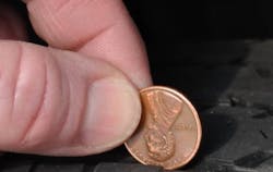 Figure 1- The distance to between the top of the penny and Abe's head is approximately 2/32'. If the penny is placed within tread (as displayed in the picture) and Abe's head is visible, the tread is too low for safe operation and the tire should be replaced. Figure 1- The distance to between the top of the penny and Abe's head is approximately 2/32'. If the penny is placed within tread (as displayed in the picture) and Abe's head is visible, the tread is too low for safe operation and the tire should be replaced.