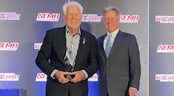 Bill Eveland, on behalf of Eveland Brothers Collision Repair, Inc., accepts the Russ Verona Memorial Award from John Van Alstyne, I-CAR CEO and president.