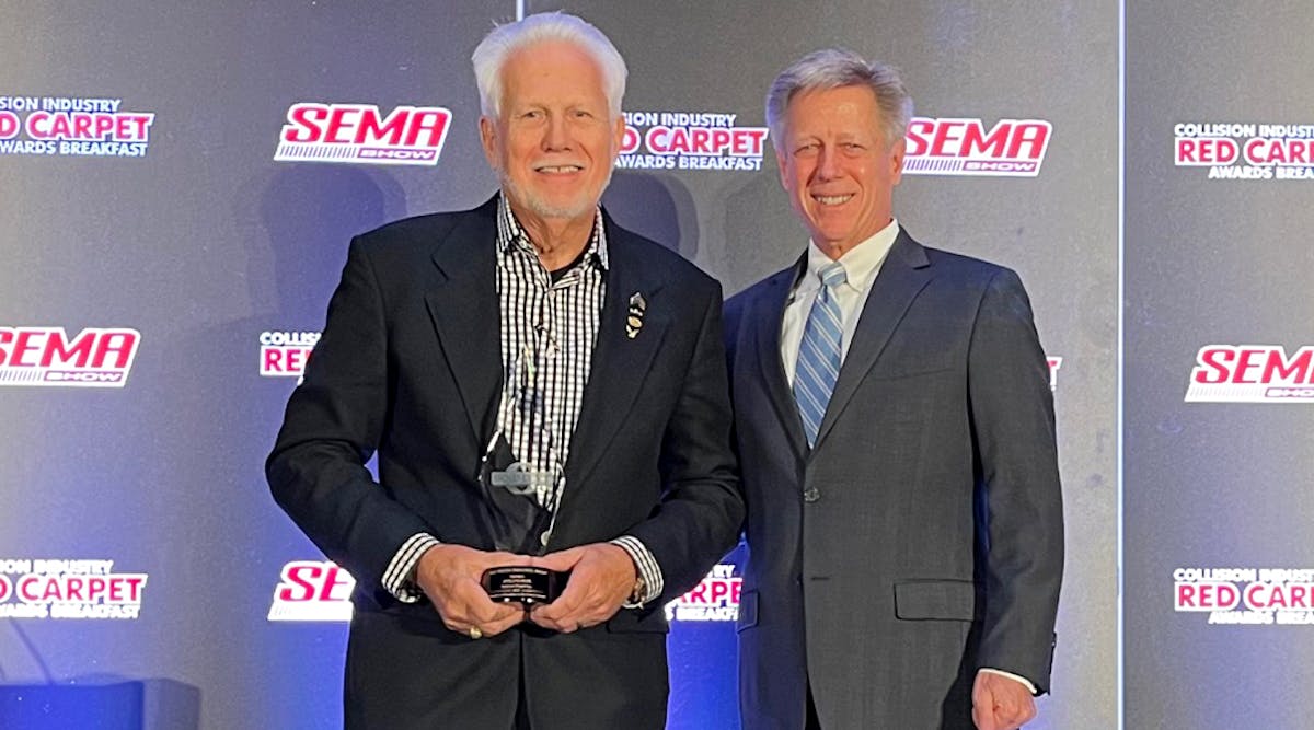 Bill Eveland, on behalf of Eveland Brothers Collision Repair, Inc., accepts the Russ Verona Memorial Award from John Van Alstyne, I-CAR CEO and president.
