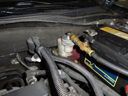 Figure 2- Brake pressure bleeder hooked up to a master cylinder reservoir. A pressure bleeder is the best way to replace the brake fluid. Figure 2- Brake pressure bleeder hooked up to a master cylinder reservoir. A pressure bleeder is the best way to replace the brake fluid.