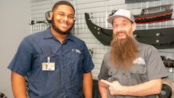 I&apos;Rule Faison (left) won the Humble Mechanic scholarship from the TechForce Foundation. YouTube influencer &apos;Humble Mechanic&apos; Charles Sanville, right, presented the award to him at the dealership where he was working while attending Universal Technical Institute&apos;s NASCAR Technical Institute.