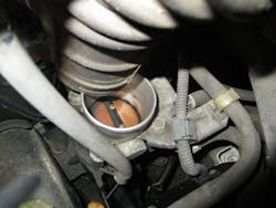 Figure9- This coked-up throttle valve prevented the engine from idling properly and was the root cause of the charging system fault. Figure9- This coked-up throttle valve prevented the engine from idling properly and was the root cause of the charging system fault.