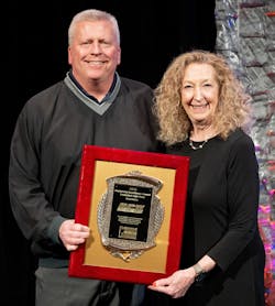 John Berrodin accepts the Federated Marketing Excellence Award for Berrodin Parts Warehouse from Sue Godschalk, president of Federated Auto Parts.