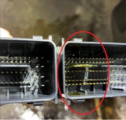 Figure 10- Ford PCM with oil ingress from a damaged sensor, wicking oil through the entire length of the engine harness. Figure 10- Ford PCM with oil ingress from a damaged sensor, wicking oil through the entire length of the engine harness.