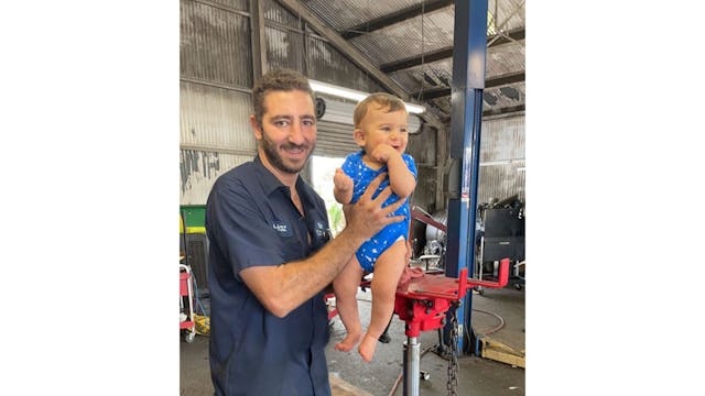 Hazem with his son in the repair shop.