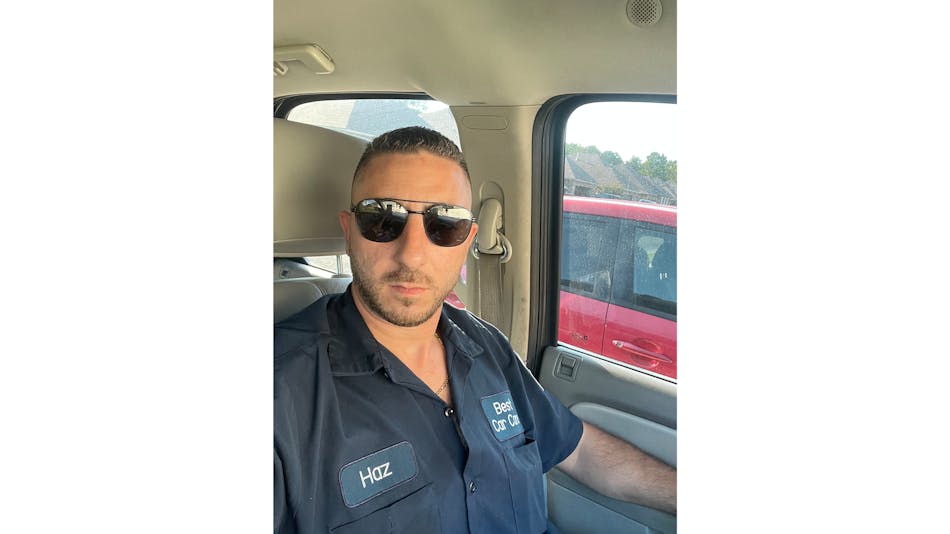 Hazem in his Best Car Care uniform, ready for work.