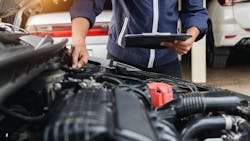 Inspecting a car underhood Inspecting a car underhood