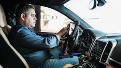 Technician with scan tool in car Technician with scan tool in car