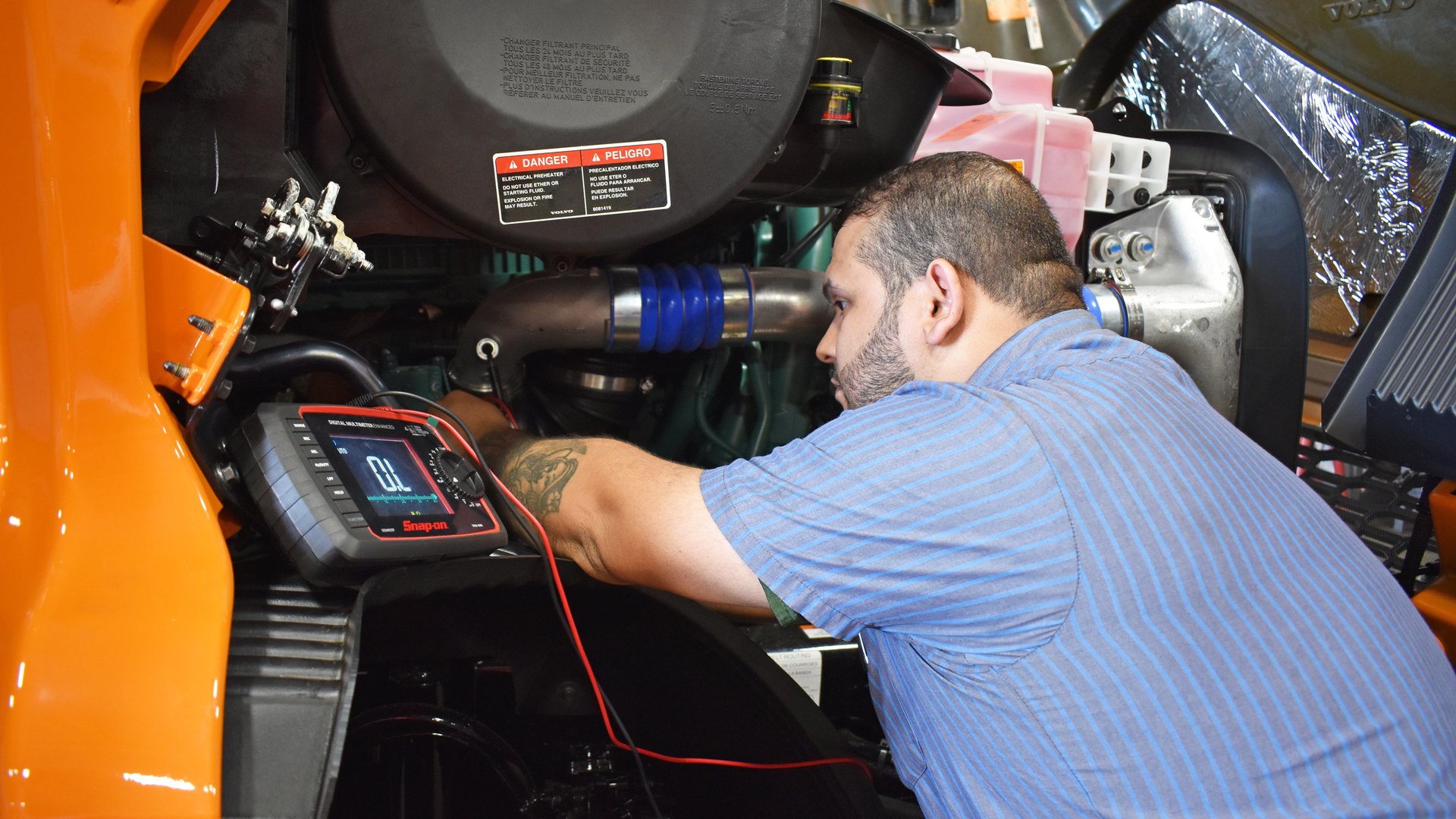 A technician from A. Duie Pyle performs diagnostics on a truck.