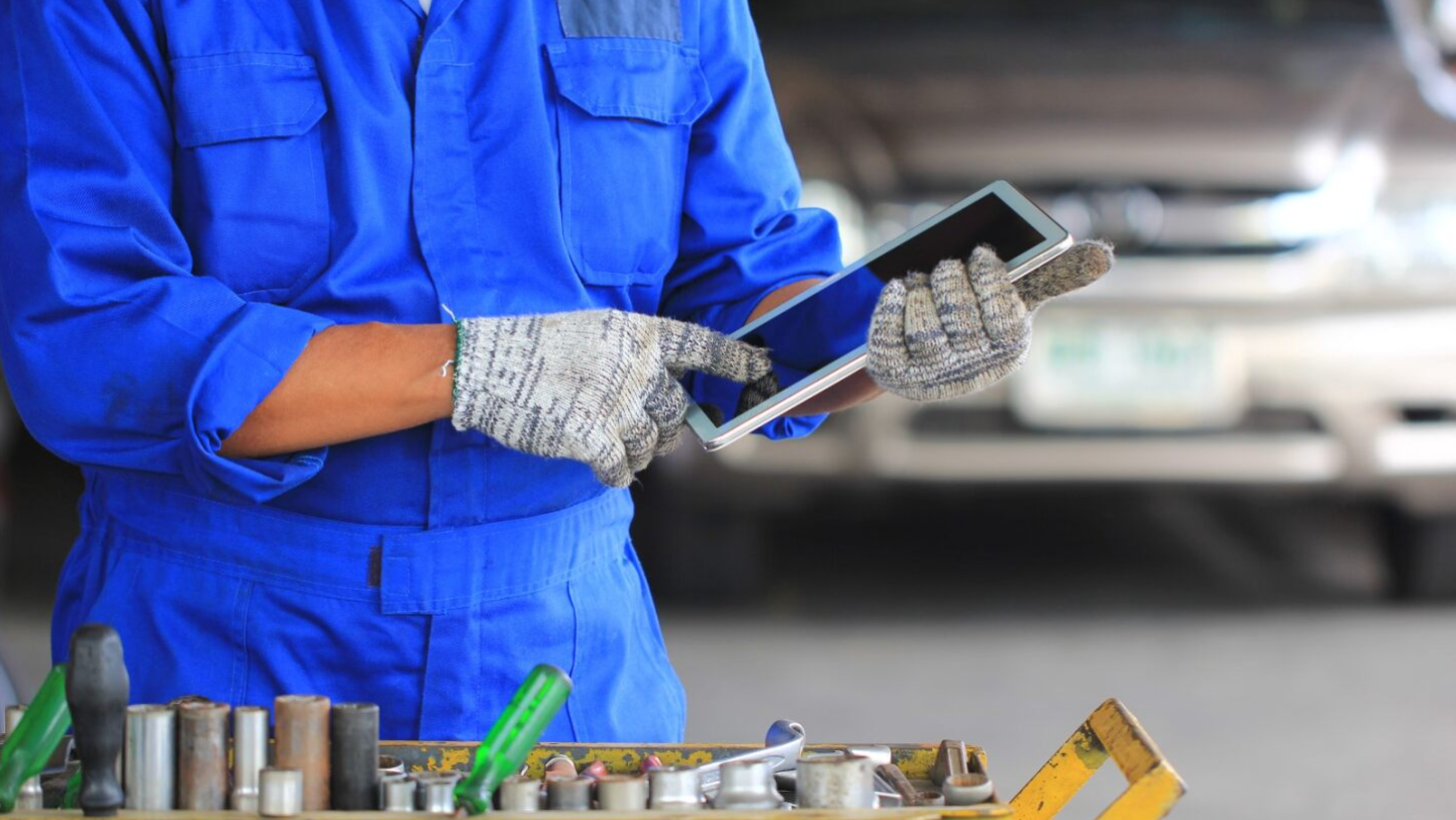 Mechanic With Tools And Tablet