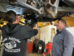Trey Magee looks on as he talks to an auto technician at Kessler Automotive, a transmission shop in Toano, Virginia.
