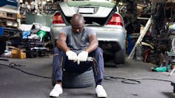 Technician resting on tire Technician resting on tire