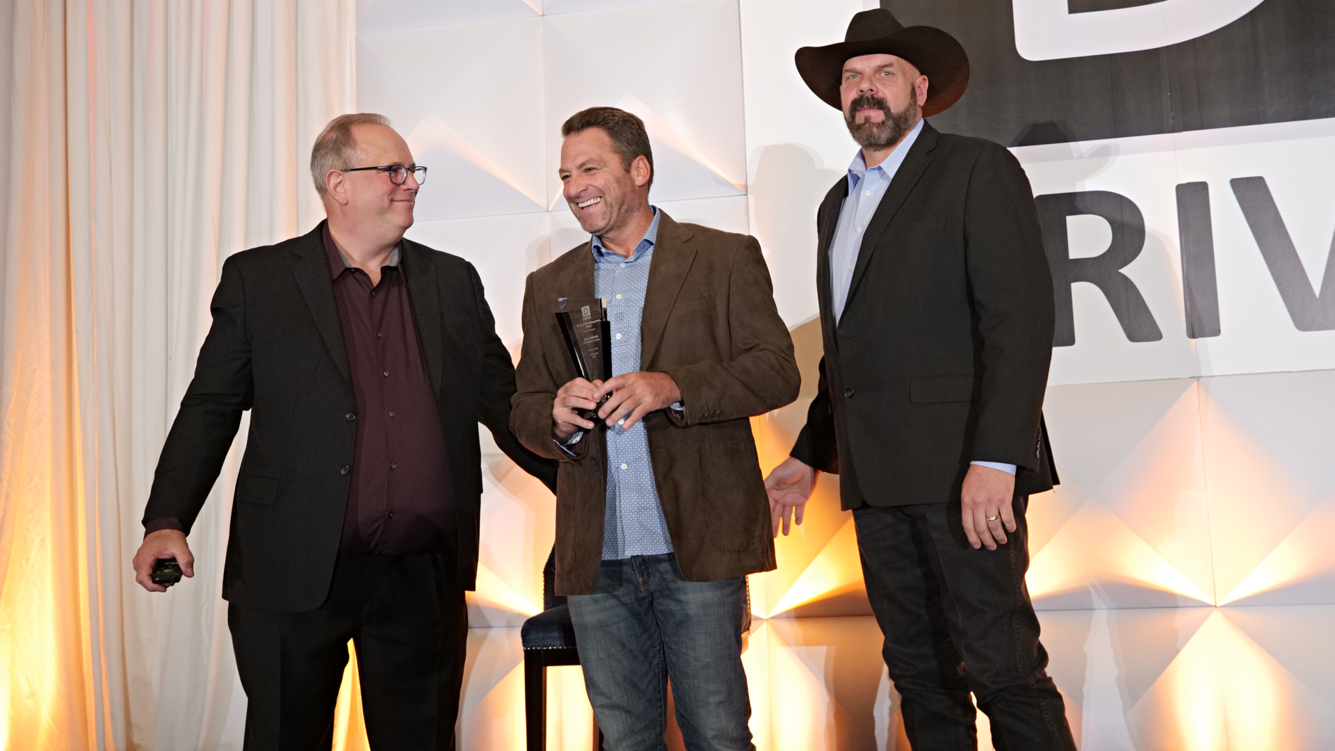 Brian Bellante (center) receives his DRIVE Masters award at the DRIVE EXPO in 2023 in Las Vegas