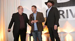Brian Bellante (center) receives his DRIVE Masters award at the DRIVE EXPO in 2023 in Las Vegas