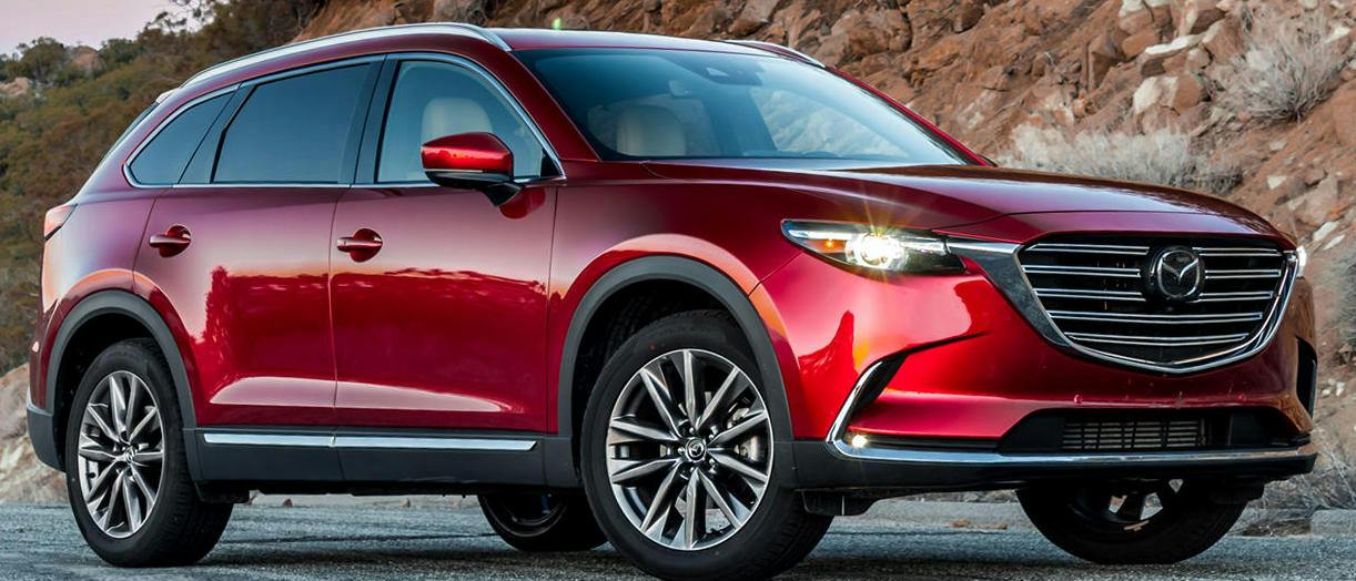 This is caused by a variable valve being stuck in the closed position. When returning from fast to normal idle, the stuck valve suddenly opens due to thermal change which causes the abnormal noise.