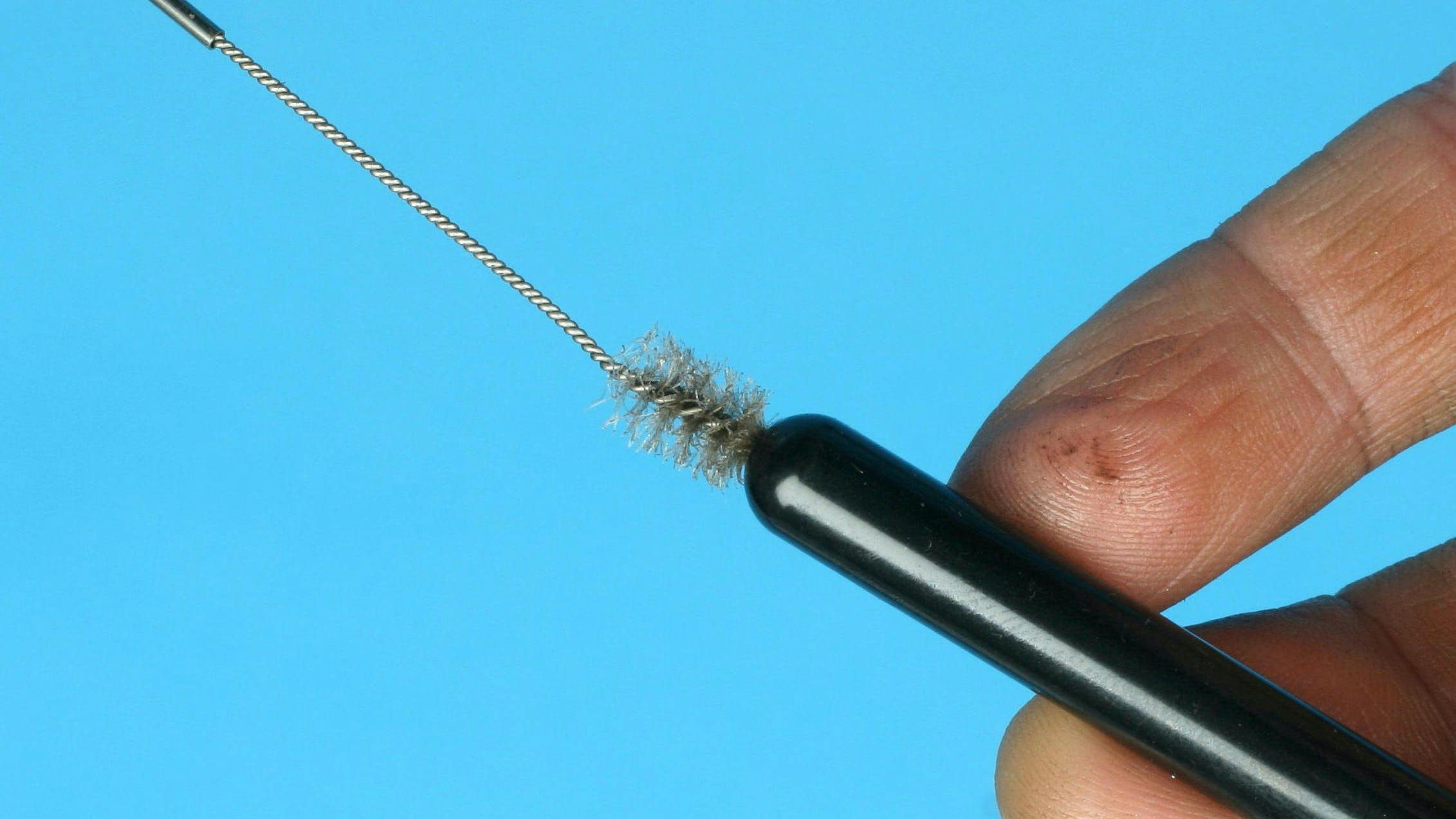 A small rifle brush works great to clean pushrod oil passages. (photo by Mike Mavrigian)