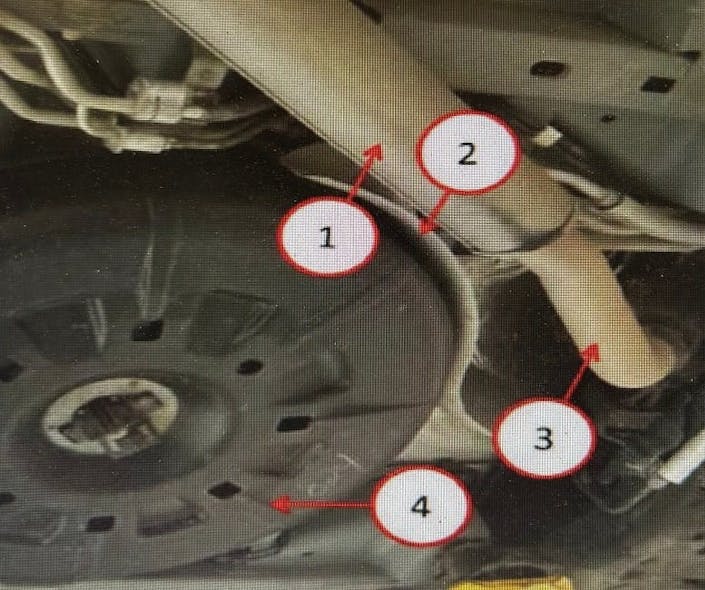 1) Spare tire heat shield hold-down screw (behind exhaust); 2) Spare tire heat shield; 3) Heat shield nut (behind the exhaust pipe); 4) Spare tire.