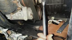 With the starter removed, rotate the crank until the bar code label on the converter is visible.