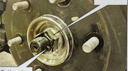 Remove the cotter pin and lock nut and push the axle inward to gain access for grease.