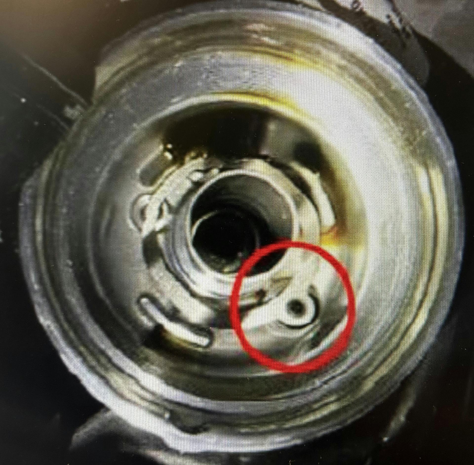 Replace the rubber oil drain plug and spring.