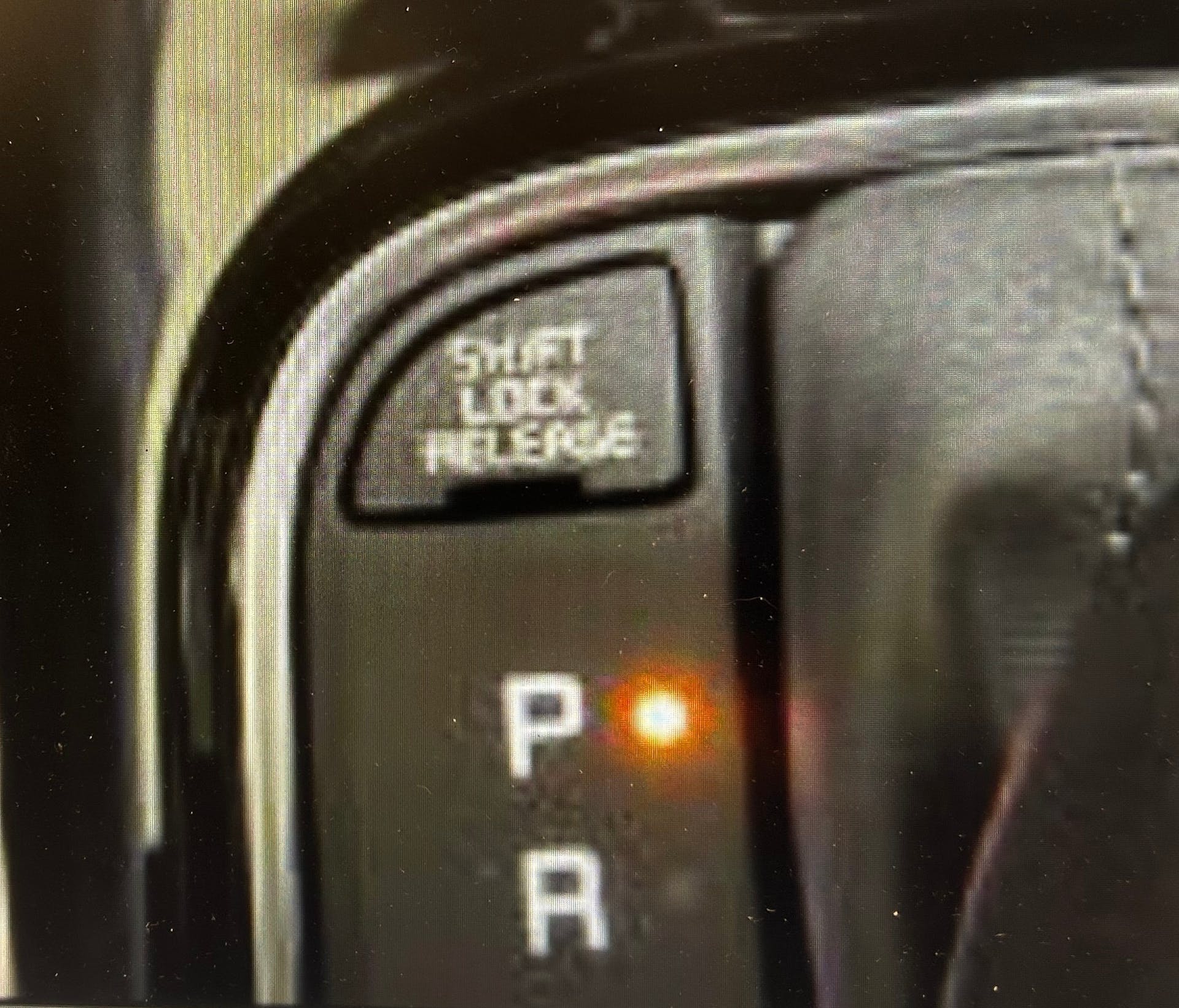 Using a pick tool, remove the Shift Lock Release tab.