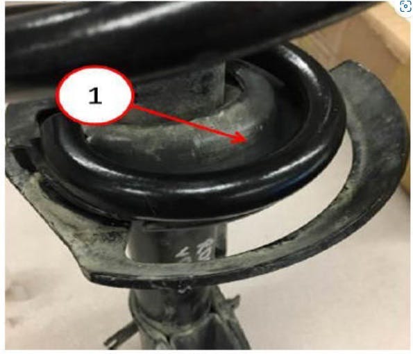 Example of incorrect assembly. Notice excessive gap between the insulator and coil spring.