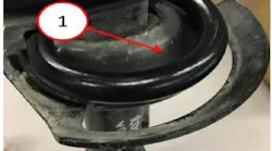 Example of incorrect assembly. Notice excessive gap between the insulator and coil spring.