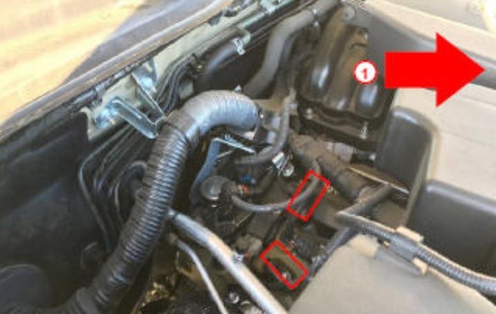 Cam sensor locations (see red rectangles). An arrow indicates the vehicle front.