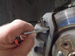 Figure 2 – The OTC gauge fits easily alongside the caliper for an accurate brake pad measurement.
