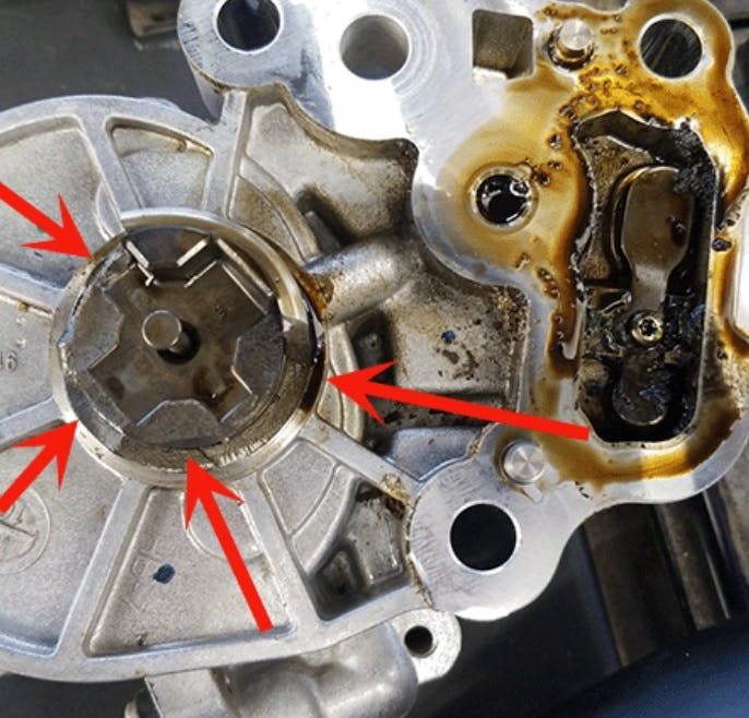 Inspect for damaged vacuum pump drive lugs (damaged example shown here).