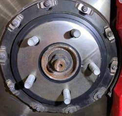 With rotors installed, apply a small amount of adhesive to the center of the friction disc. The photo shows friction disc installed on the rotor. With rotors installed, apply a small amount of adhesive to the center of the friction disc. The photo shows friction disc installed on the rotor.