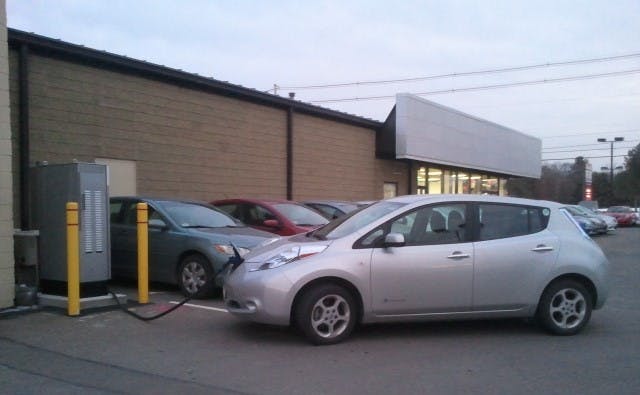 Checking a Nissan Leaf at a DC charging station.