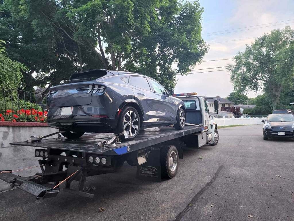 A Ford Mustang Mach-E off to a shop with a no-READY condition.