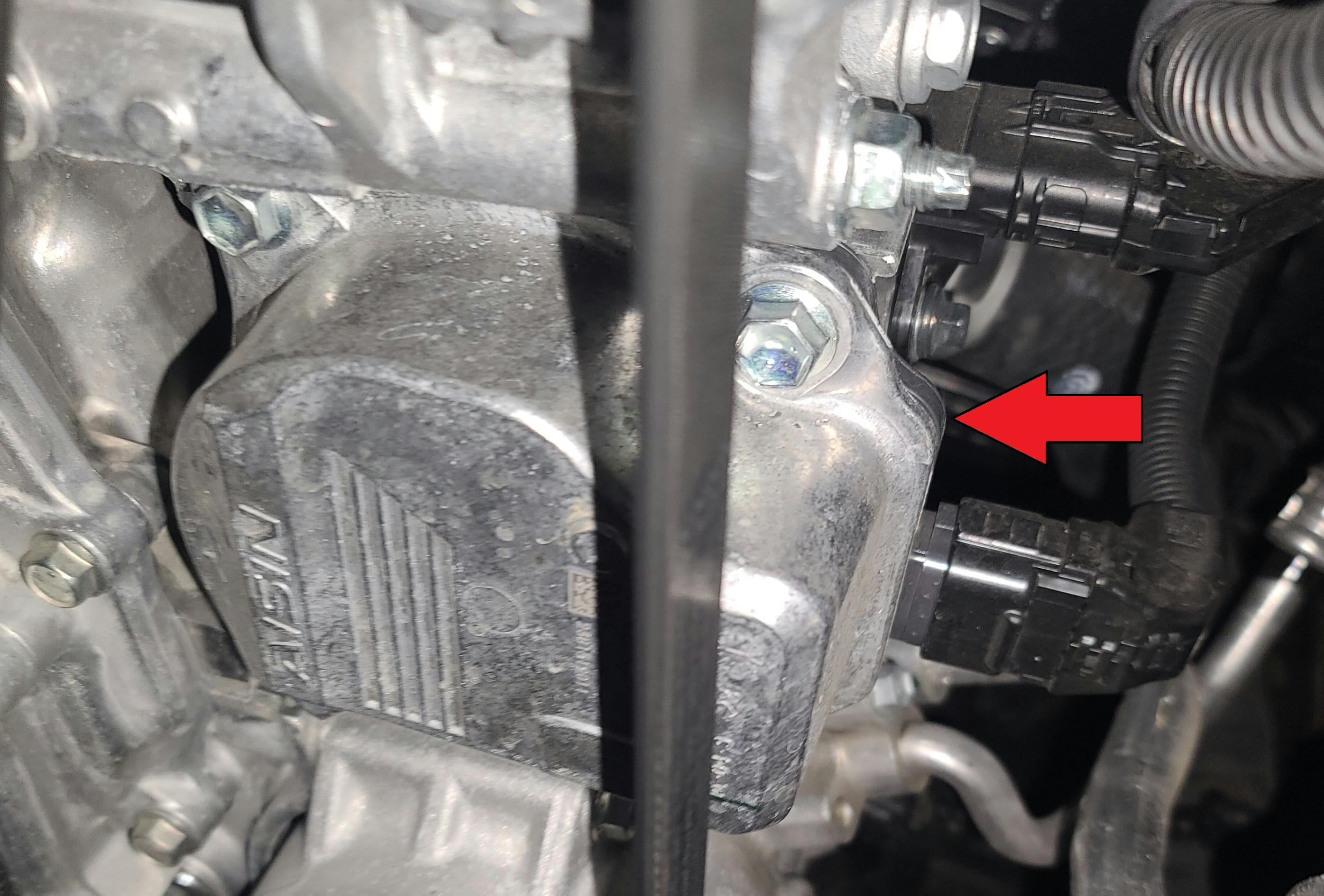 This is the electric water pump, mounted to the block just above the AC compressor. The mapped thermostat is mounted to the back of the water pump (out of view).