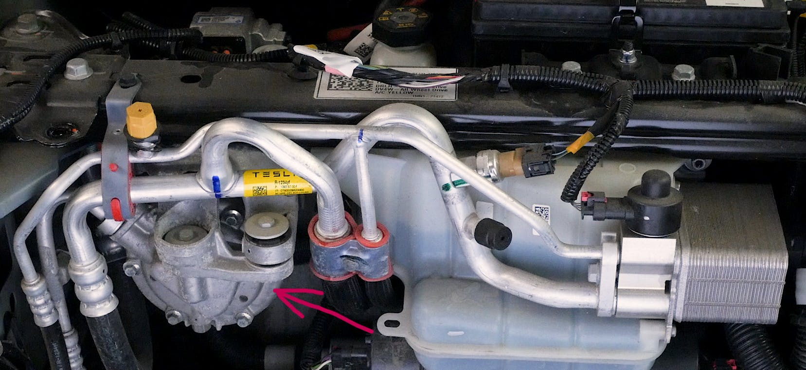 This shows the location of the electric A/C compressor on a Tesla. It is mounted near the firewall near the HVAC assembly so quiet operation is a must.