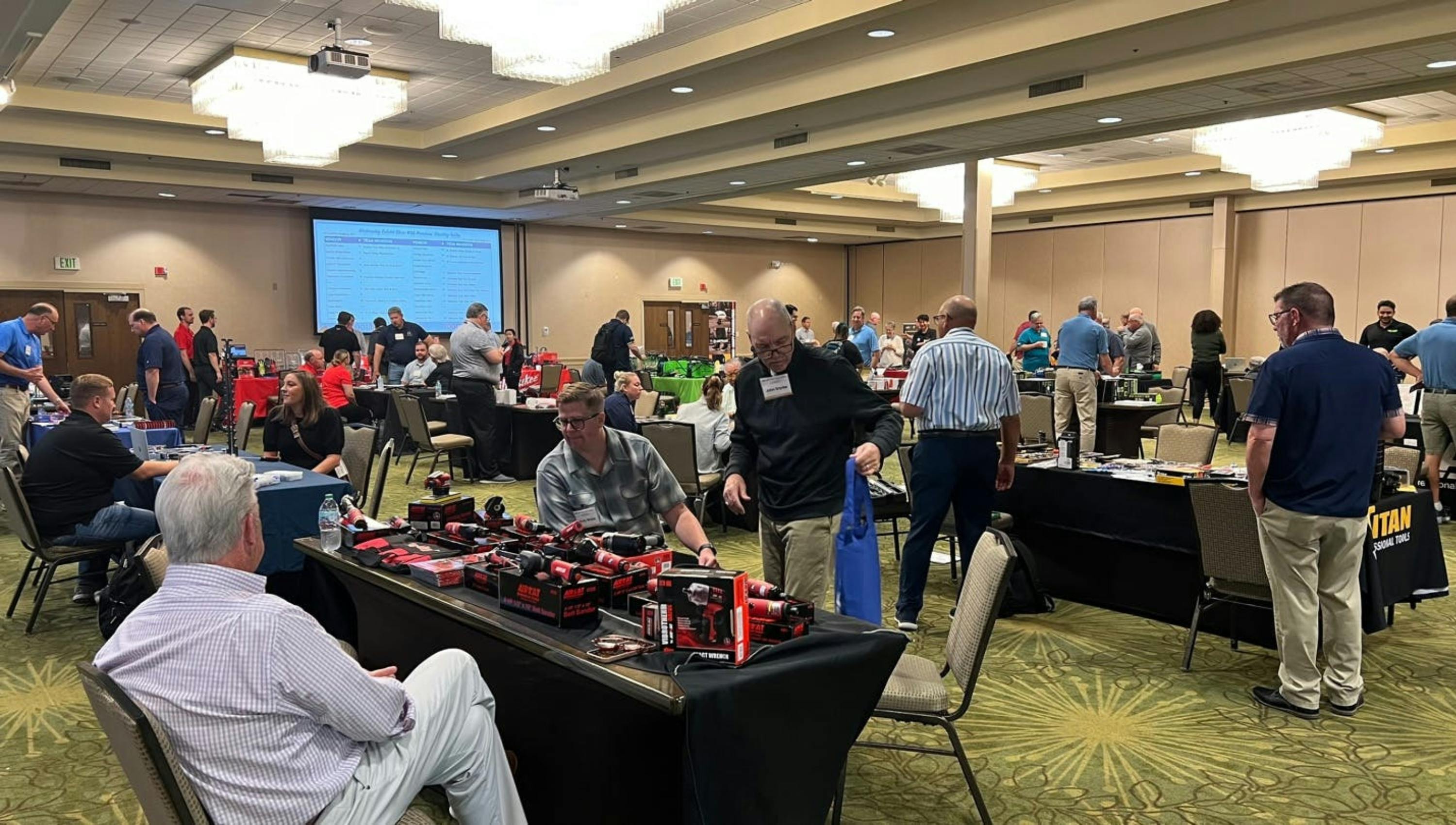 An AIRCAT representative talks to attendees and shows them the tools AIRCAT has on display.