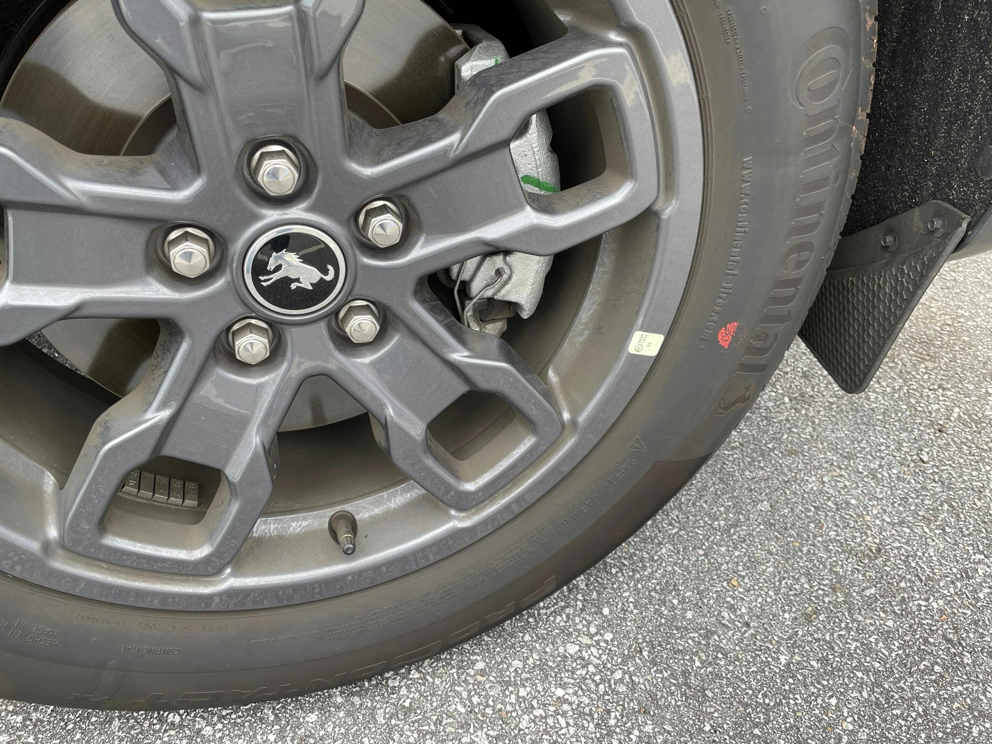Example of a tire mounted. This tire features only a red dot, with no yellow dot. The wheel features a sticker indicating the wheel low point. The tire is mounted to align the red dot (highest point of radial runout) to this sticker.