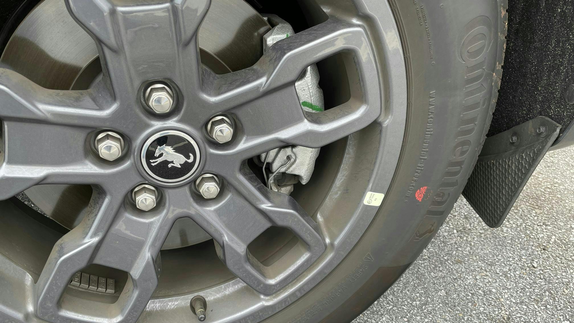 Example of a tire mounted. This tire features only a red dot, with no yellow dot. The wheel features a sticker indicating the wheel low point. The tire is mounted to align the red dot (highest point of radial runout) to this sticker.