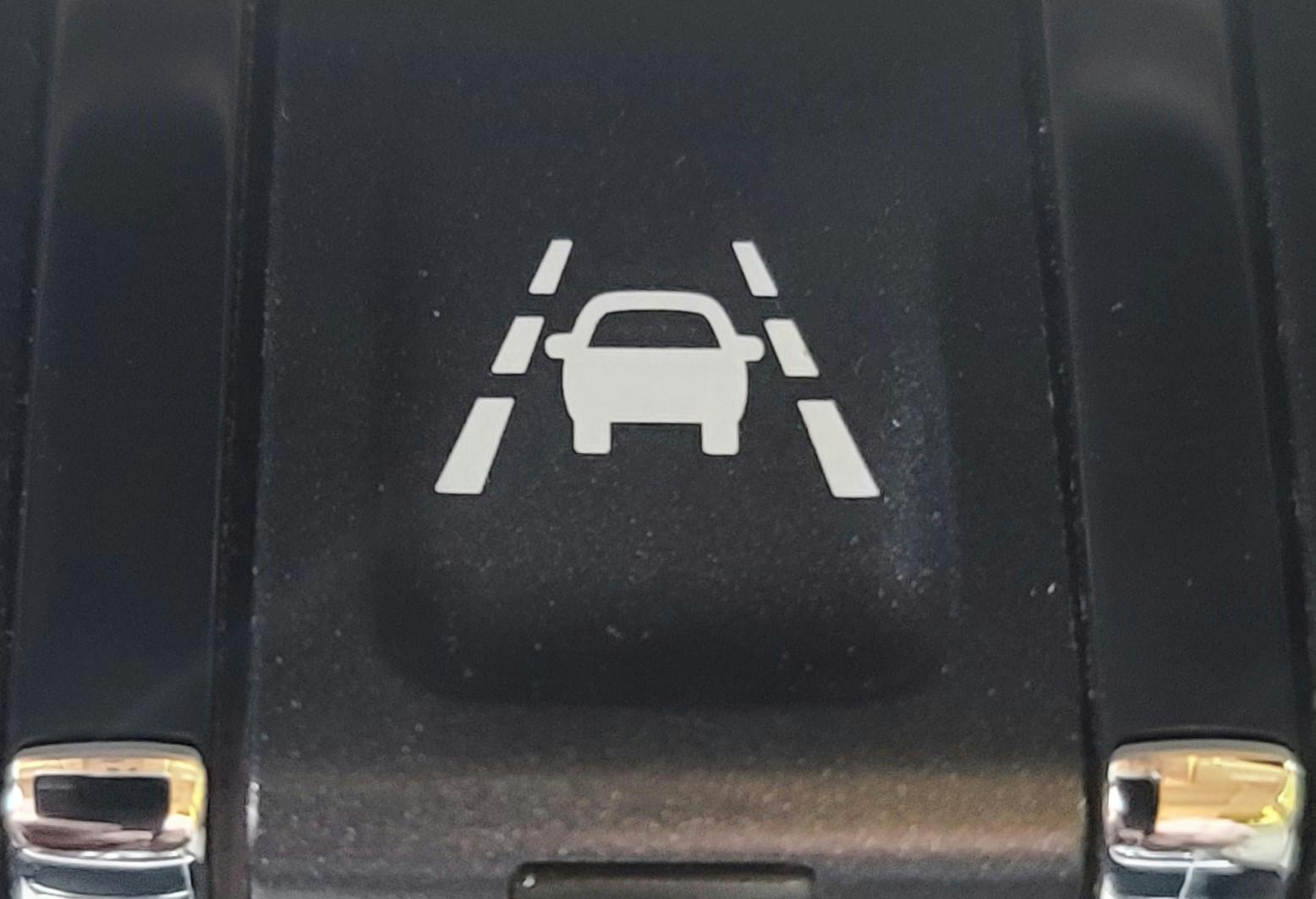 The Lane Keep Assist (LKA) switch on this 2019 GMC Sierra will activate the LKA system. The LKA system will use the forward-facing camera to adjust the steering wheel if the vehicle approaches a detected lane marking.