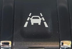 The Lane Keep Assist (LKA) switch on this 2019 GMC Sierra will activate the LKA system. The LKA system will use the forward-facing camera to adjust the steering wheel if the vehicle approaches a detected lane marking. The Lane Keep Assist (LKA) switch on this 2019 GMC Sierra will activate the LKA system. The LKA system will use the forward-facing camera to adjust the steering wheel if the vehicle approaches a detected lane marking.