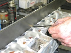 Using a machinist’s precision straightedge and feeler gauge, check head flatness along the length of the head deck. Using a machinist’s precision straightedge and feeler gauge, check head flatness along the length of the head deck.