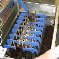 Pressure testing a cylinder head. All water ports are plugged except for one, where compressed air is introduced. Any cracks or porosity issues will be evident by air bubbles escaping. Pressure testing a cylinder head. All water ports are plugged except for one, where compressed air is introduced. Any cracks or porosity issues will be evident by air bubbles escaping.