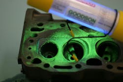 An ultraviolet lamp (black light) is placed over the workpiece. An ultraviolet lamp (black light) is placed over the workpiece.